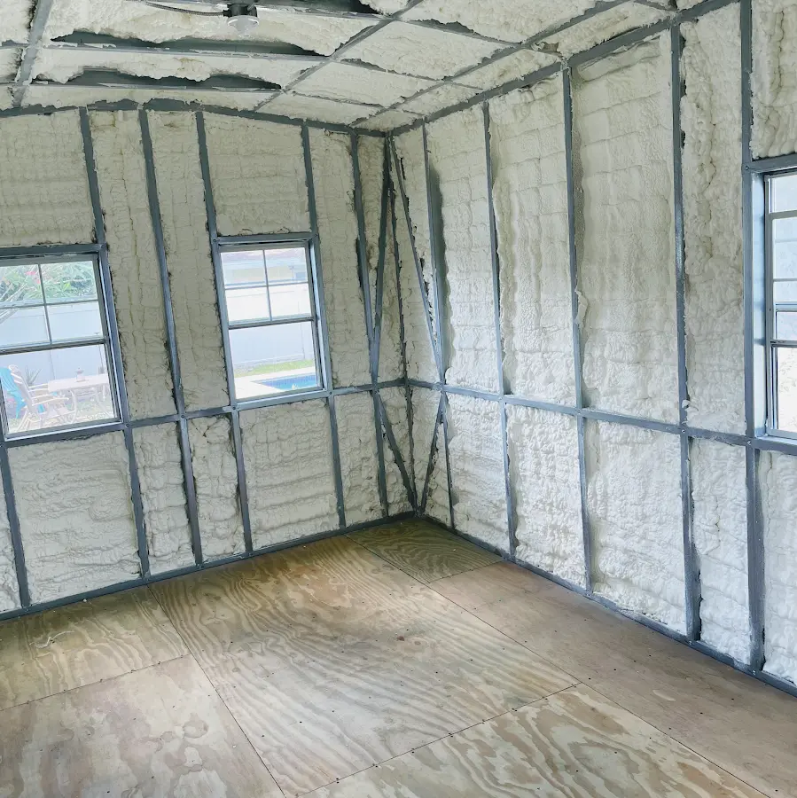 Closed-cell spray foam insulation applied to wall cavities in a residential project in Springdale